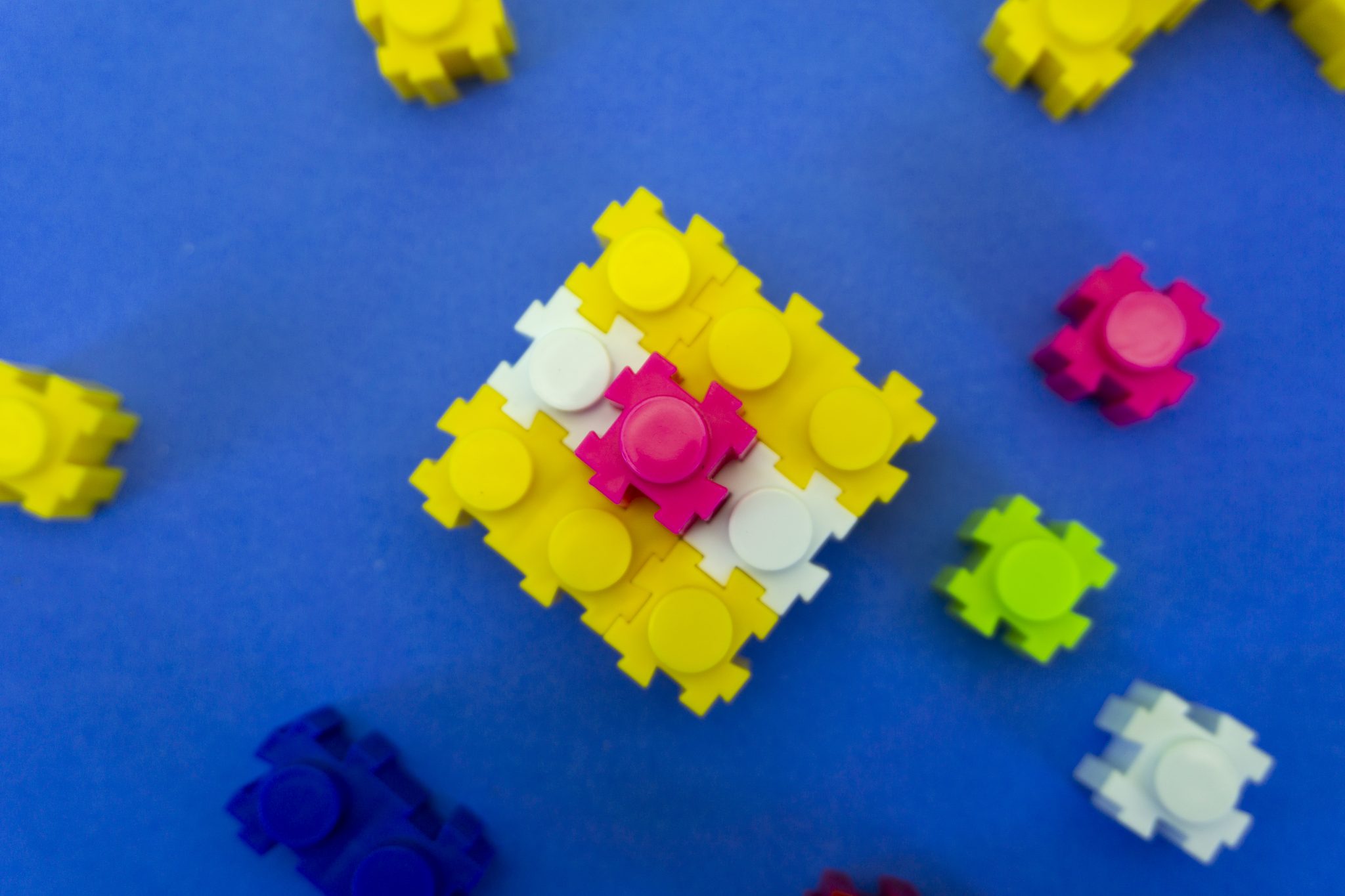 Lego Building Block. Tiny pieces made into a 3x3 grid, with other tiny pieces standing alone around it.