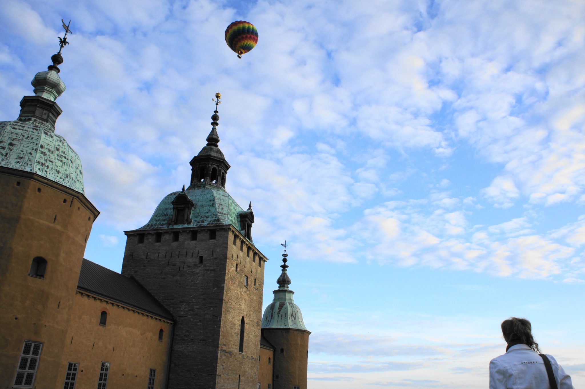 The Castle of Kalmar in Sweden under a blue sky and a colorful air balloon