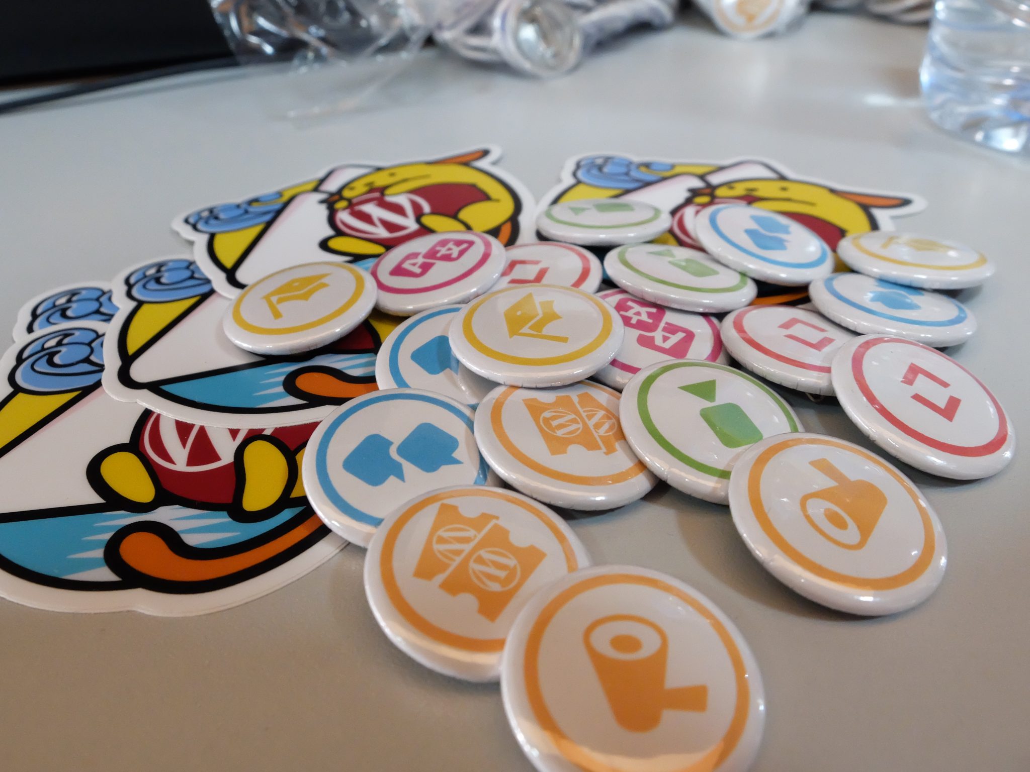 WordPress.org contributor pins on a table at WC Chiclana 2017.