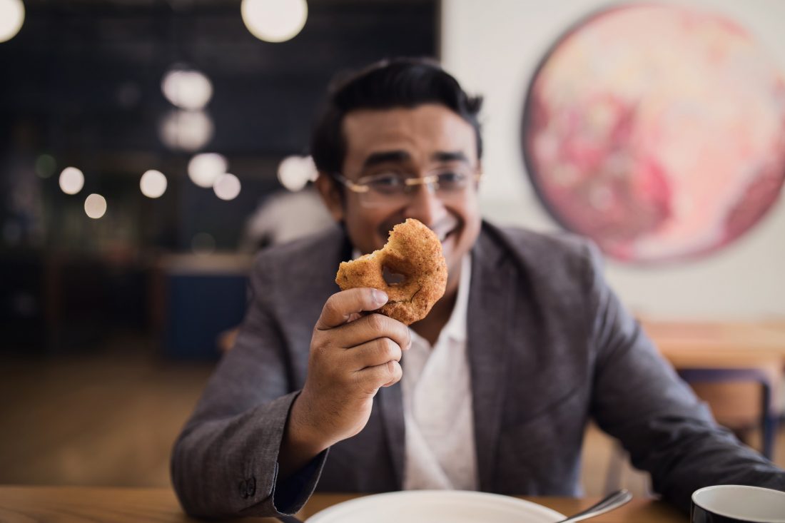 Businessman holding donut