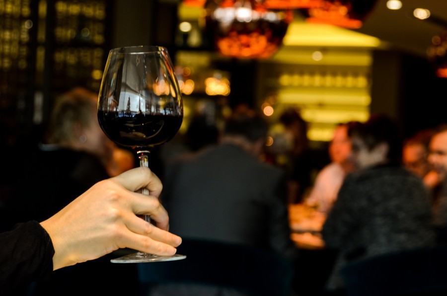 Holding a glass of wine