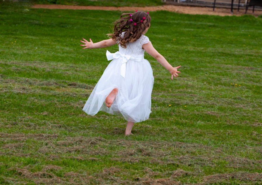 Bridesmaid running on grass