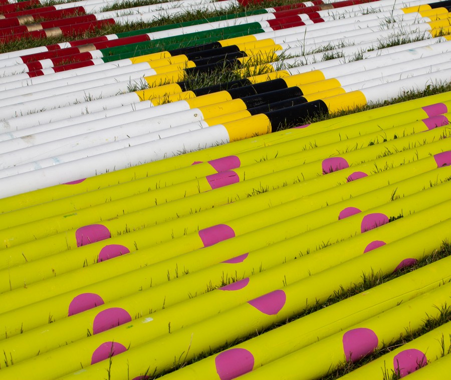 Coloured poles laying on grass