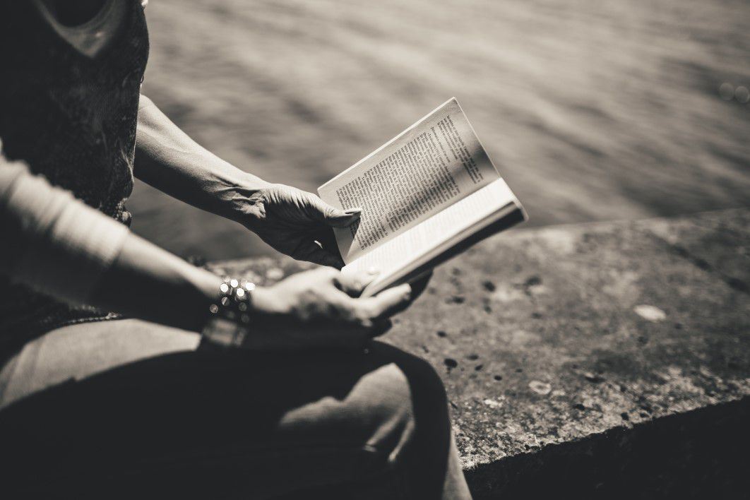 B&W Woman Reading Book in Park