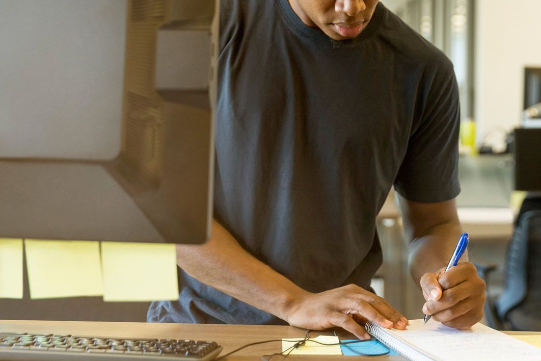 Man Taking Notes Computer